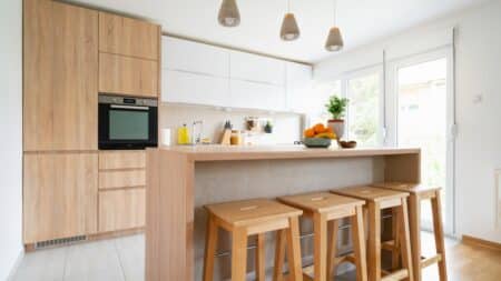 House cleaning professionals servicing a bright kitchen in neighborhoods.
